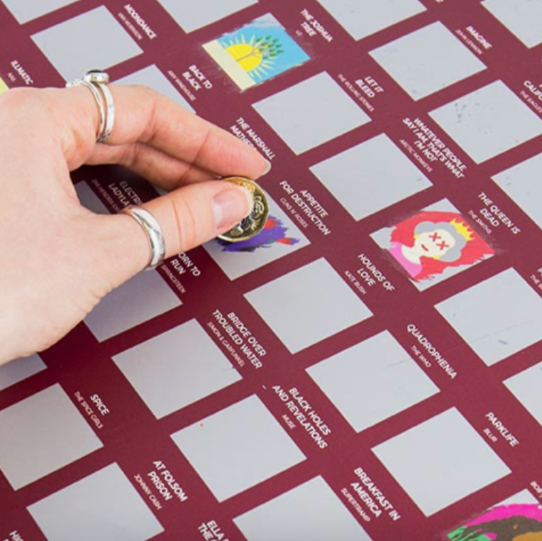 close up picture of a hand using a coin to scratch 'Born To Run' from the 100 album bucket list poster