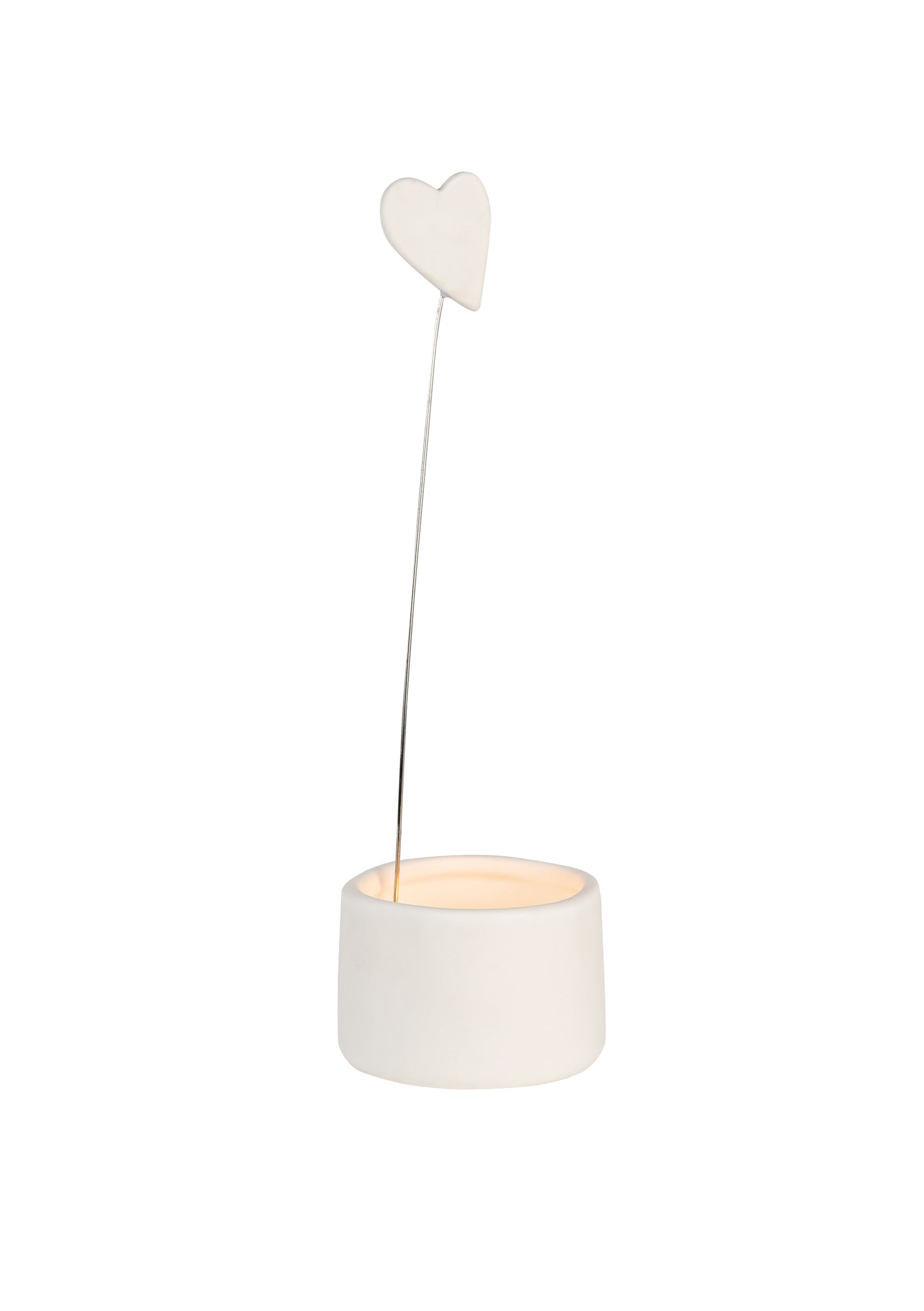 white porcelain tealight holder with suspended heart motif