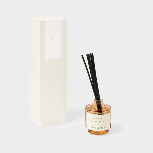 reed diffuser with amber glass and box with 'Home' on the label