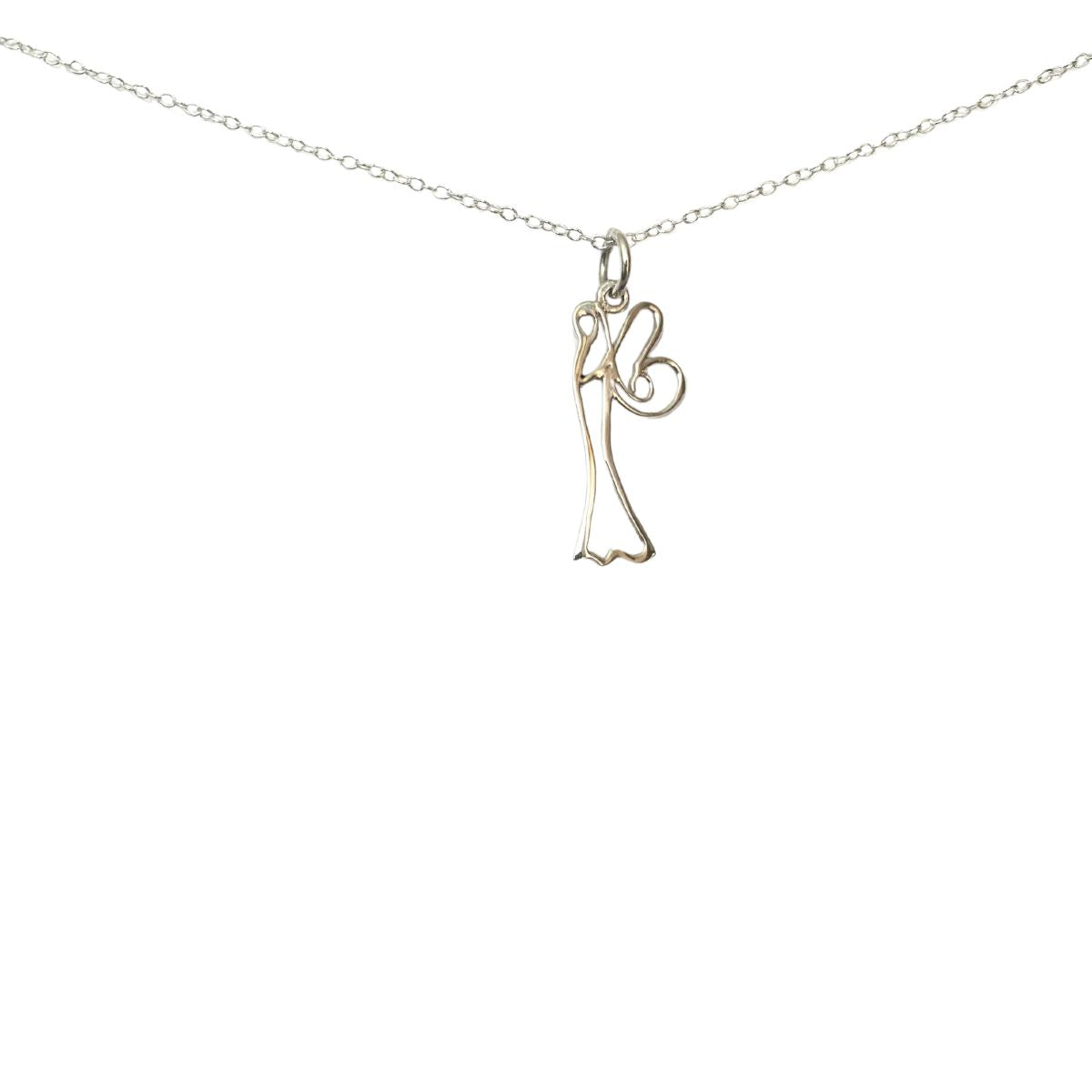 close up view of a silver pendant necklace. The pendant is the outline of a sidewards-facing fairy.
