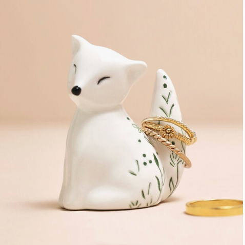 ceramic fox ring holder with floral design and 3 gold rings on the tail
