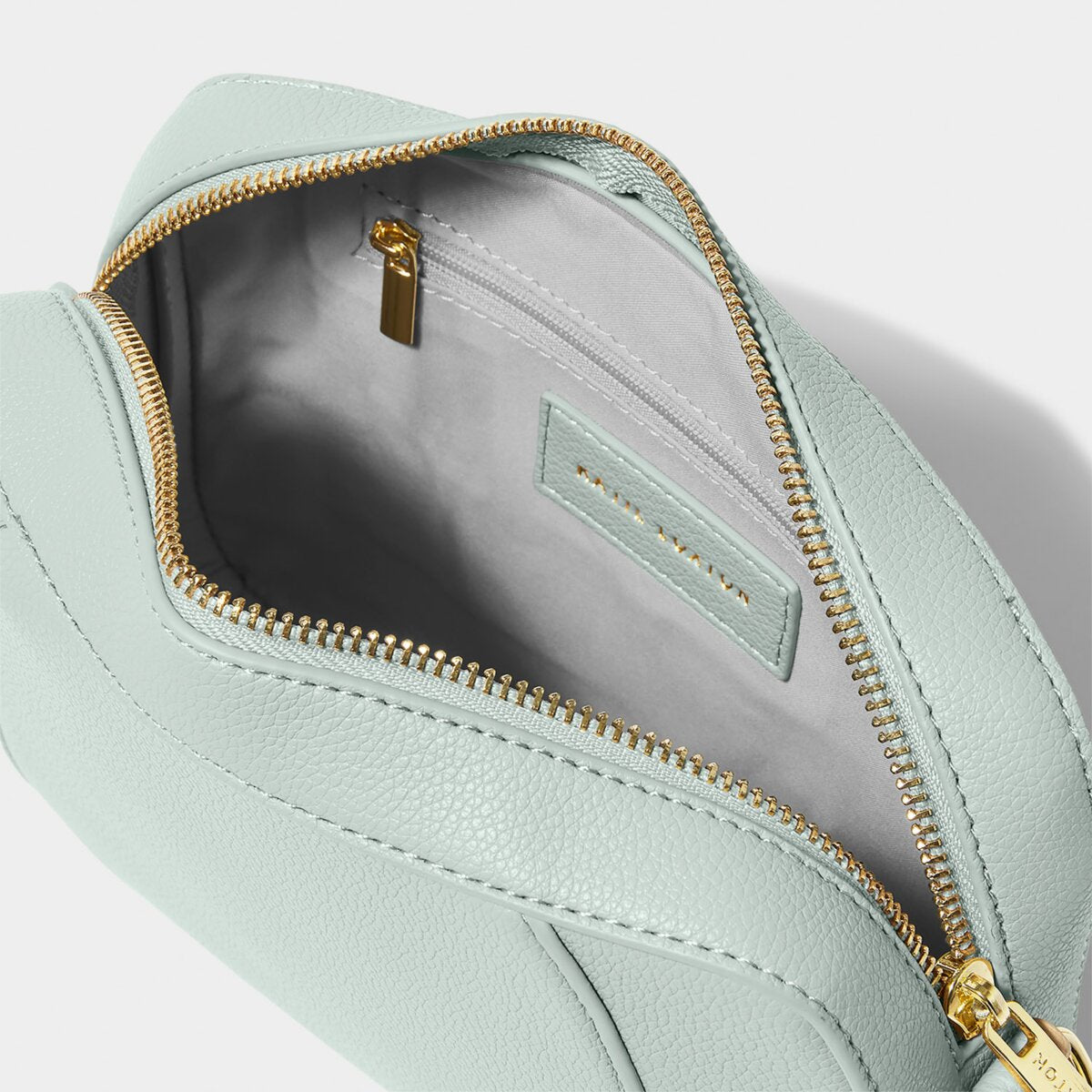 Interior shot of duck egg blue crossbody handbag showing zipped inside pouch