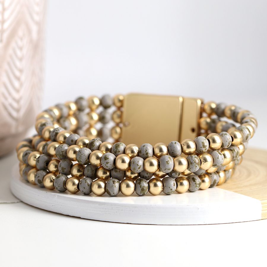 Golden and distressed grey bead multi strand bracelet
