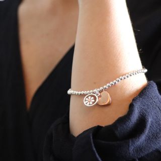 Silver plated stretch bracelet with daisy and heart charms