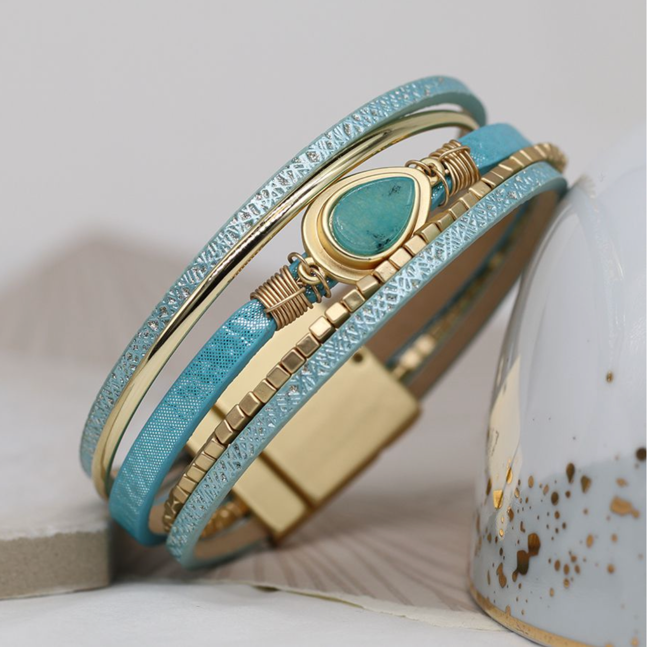 Aqua leather and golden bracelet with aqua teardrop stone