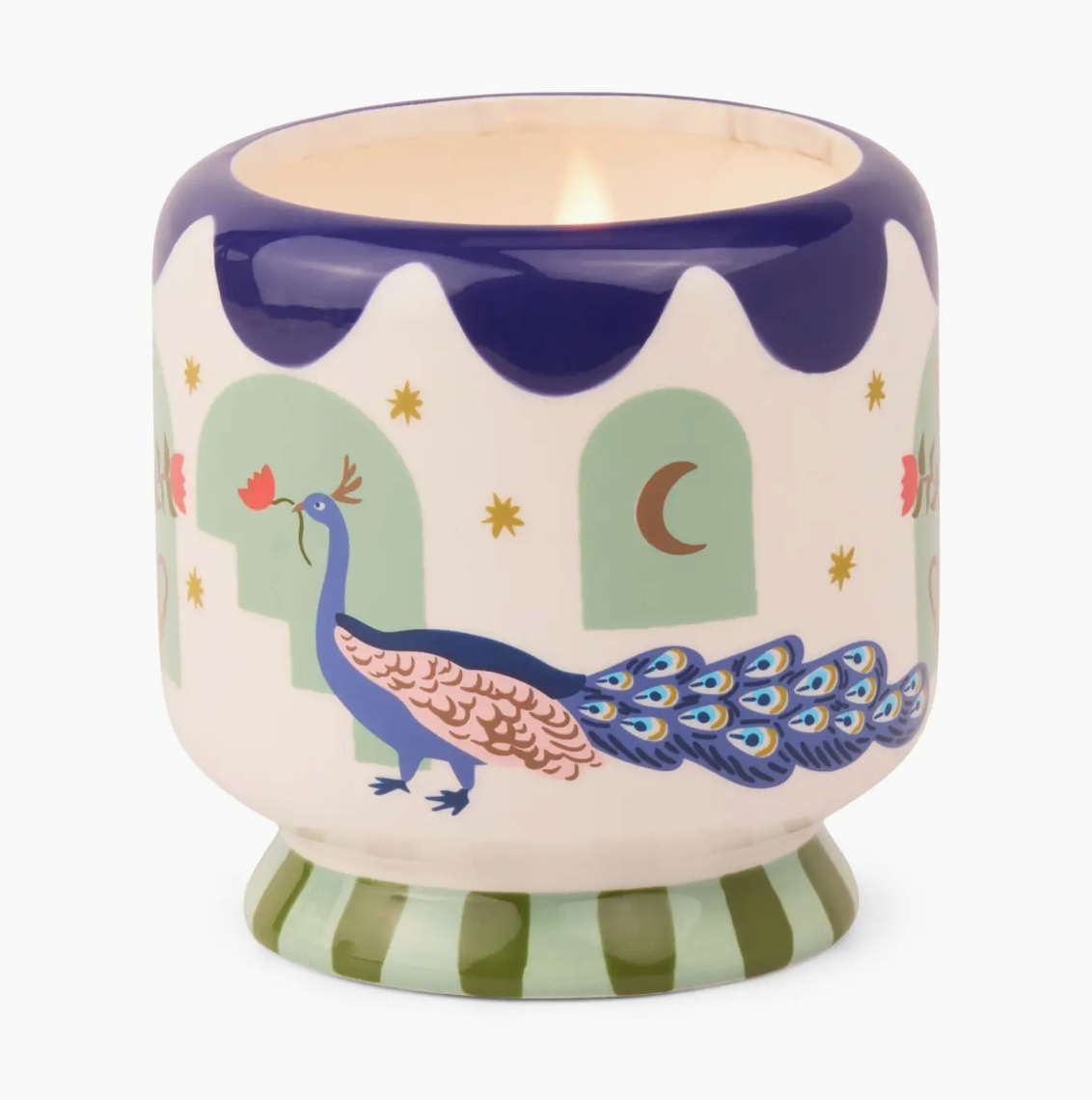 Scented candle in a cermaic pot decorated with a peacock motif, a blue wavy border and a green striped base. 