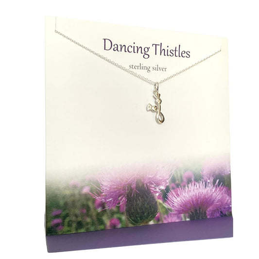 silver pendant necklace with two entiwined thistles on a silver chain. Presented on a gift card saying "Dancing Thistles" with a picture of purple thistles at the bottom of the card
