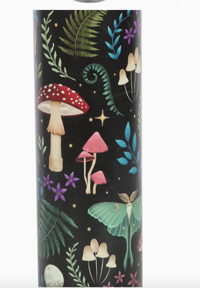 Close up of Glass tube scented candle with a 'mystical forest' design with toadstools, moths and various foliage. 