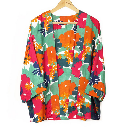 summer kimono with a vibrant floral print in green, orange and pink against a white background