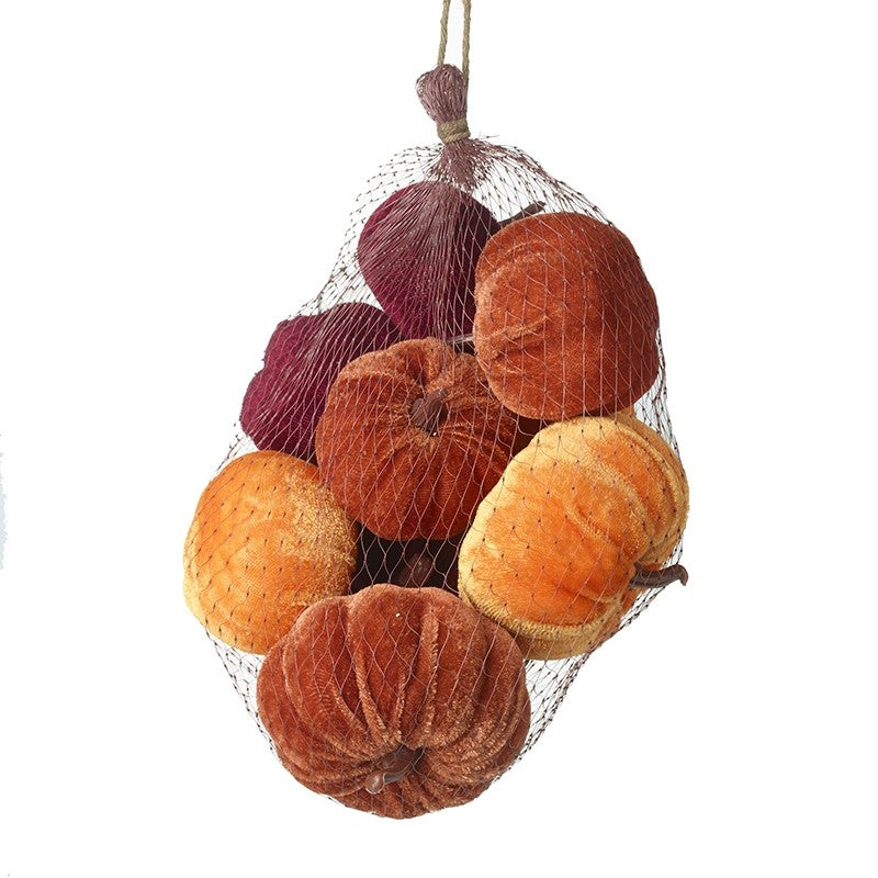 net bag filled with velvet pumpkin decorations in shades of orange, red and brown