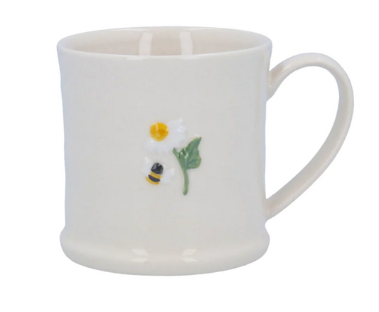 ceramic mug featuring a bumble bee next to a white daisy with yellow centre, green stem and leaf embossed motif
