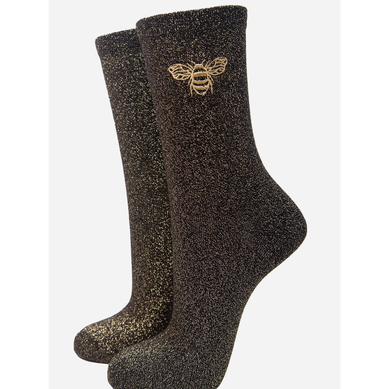 a pair of black socks, with sparkly gold embroidered bee