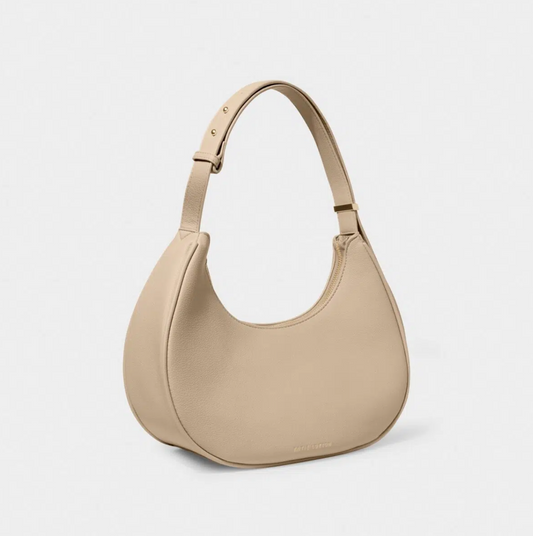 scoop shaped handbag in a light taupe colour with gold zip and gold adjustable strap studs against a white background