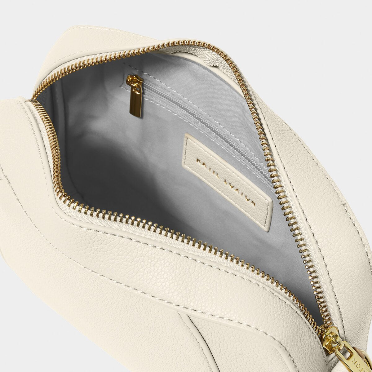 internal shot of off-white crossbody bag  with grey lining and zipped internal pocket