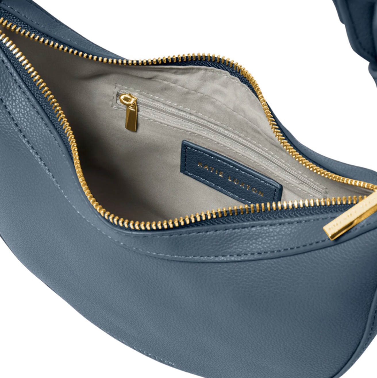 interior of Katie Loxton marni scoop bag in navy.  Shows grey lining fabric and interior side pocket with zip
