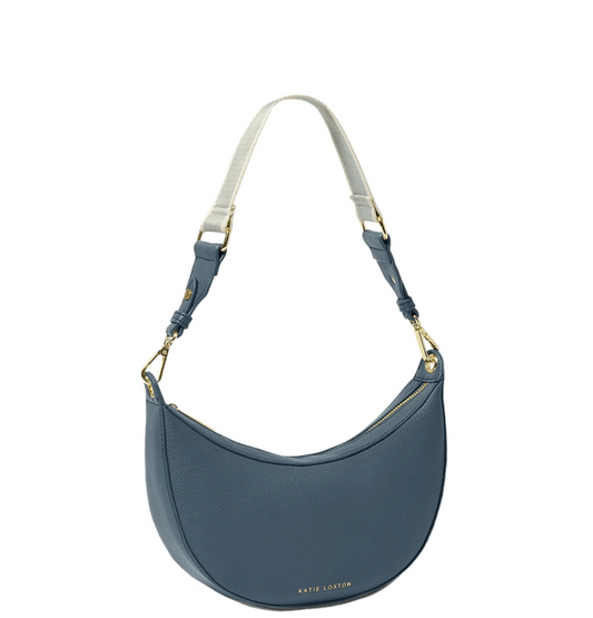 light navy blue scoop shaped hand bag with detatchable strap against a white background