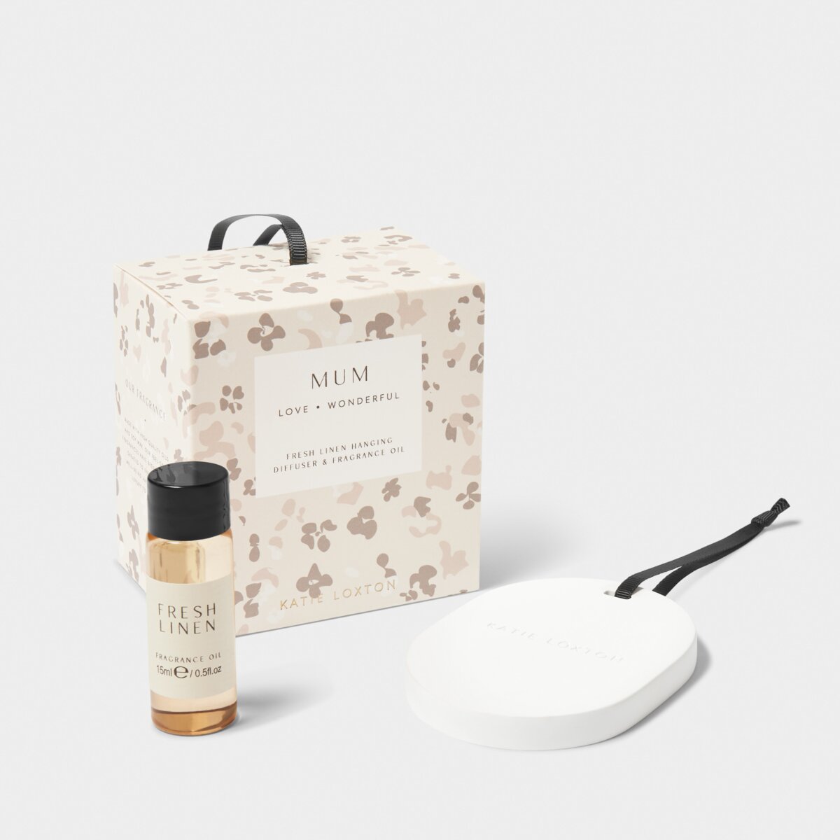 floral box saying 'Mum', Fresh Linen scented diffuser oil and ceramic pebble-shaped diffuers hanger against a white background