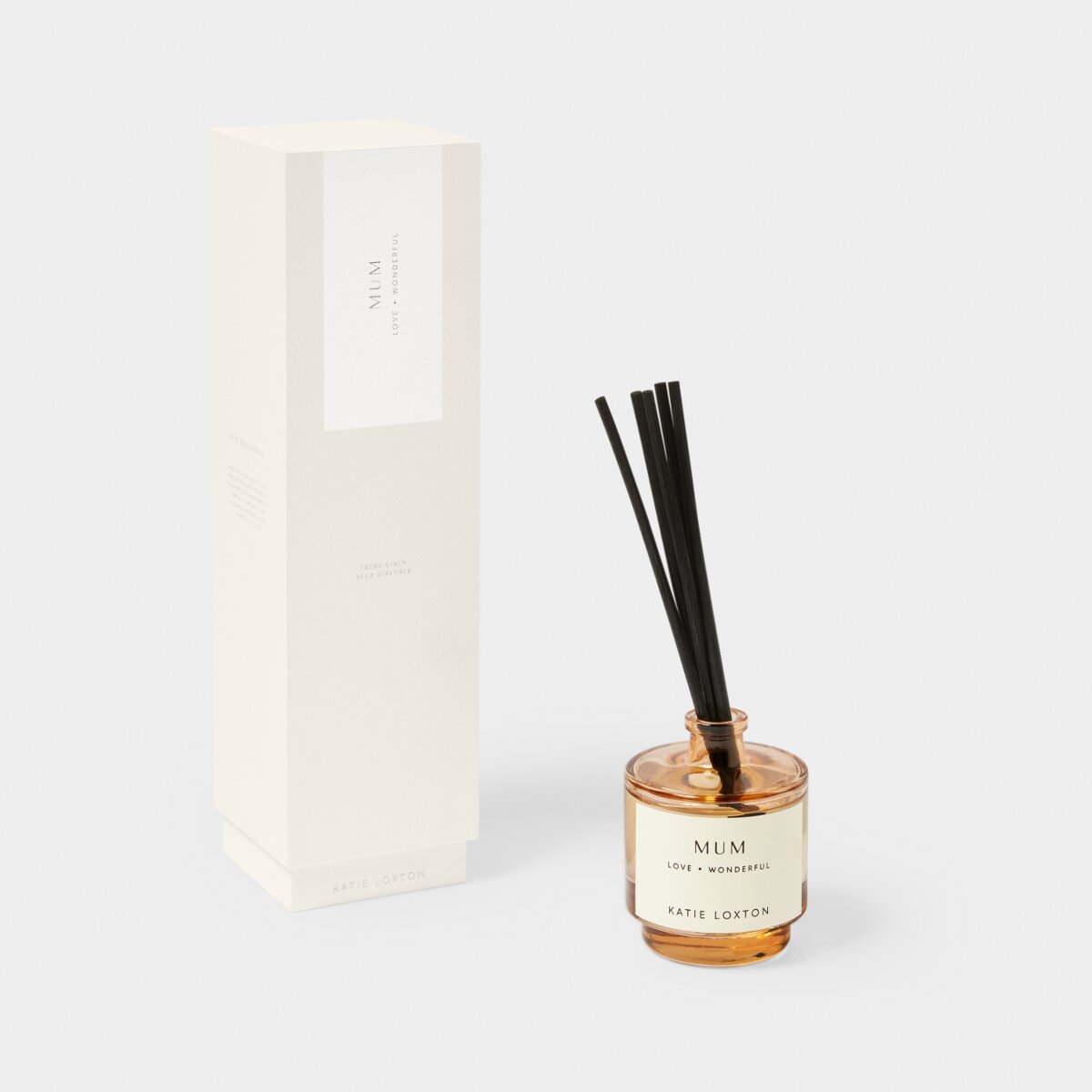 Reed diffuser in an amber coloured jar with black reeds. Diffuser jar says Mum