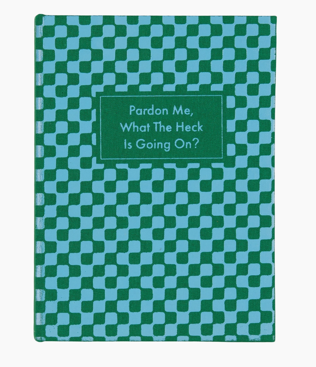 Notebook with green and teal checked cover, with Pardon me, What The Heck Is Going On? Written on the front cover.