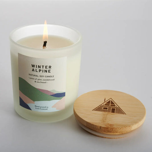 Winter alpine scented candle against a white background