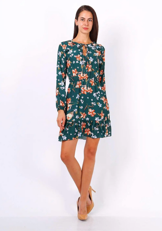 Model wearing green dress with orange and white floral print with nude shoes