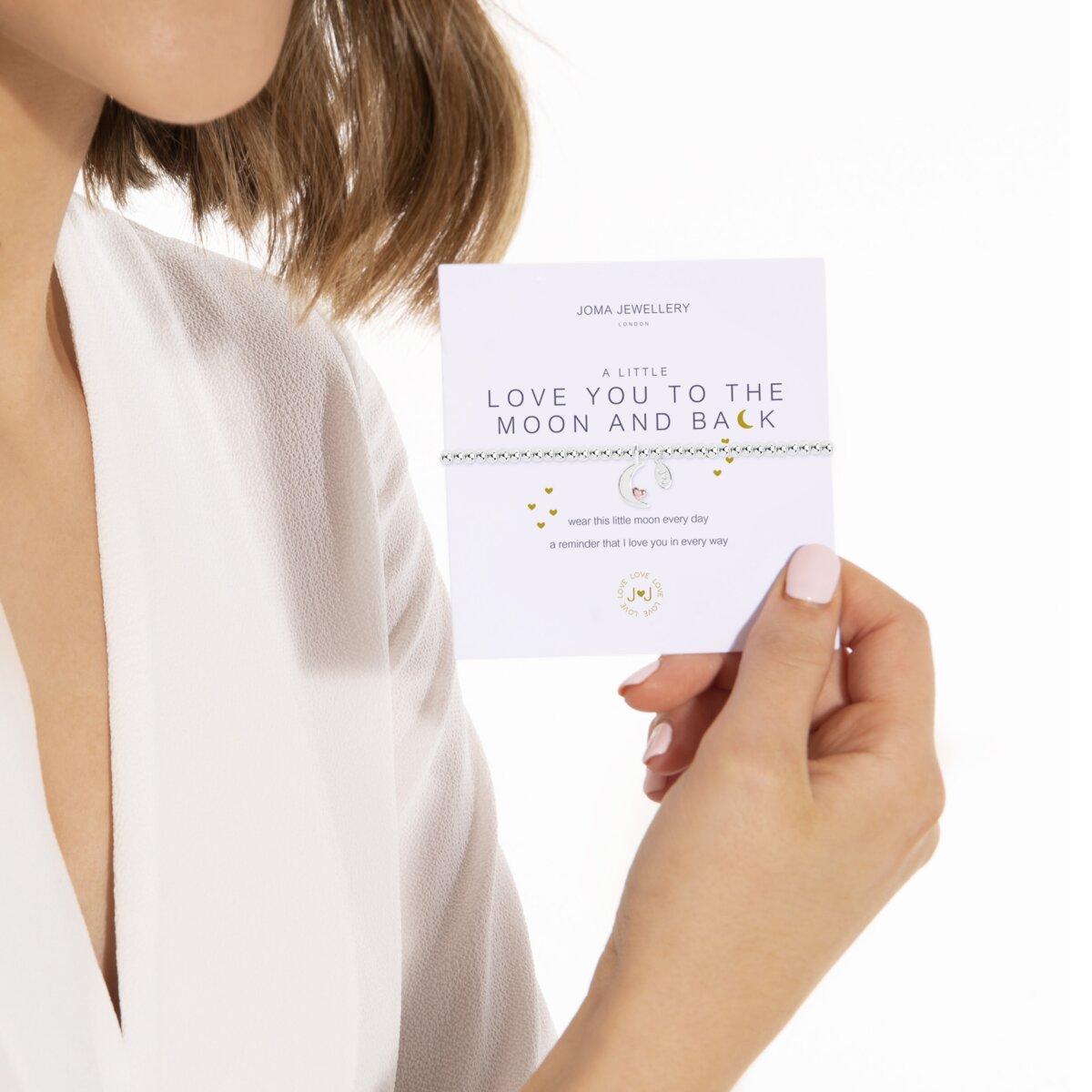 Model Holding Joma Jewellery Love You To The Moon and Back Silver Plated Bracelet on Presentation Gift Card